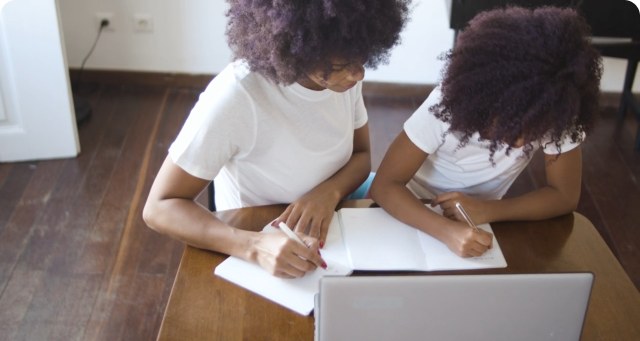 Two students working together at a table